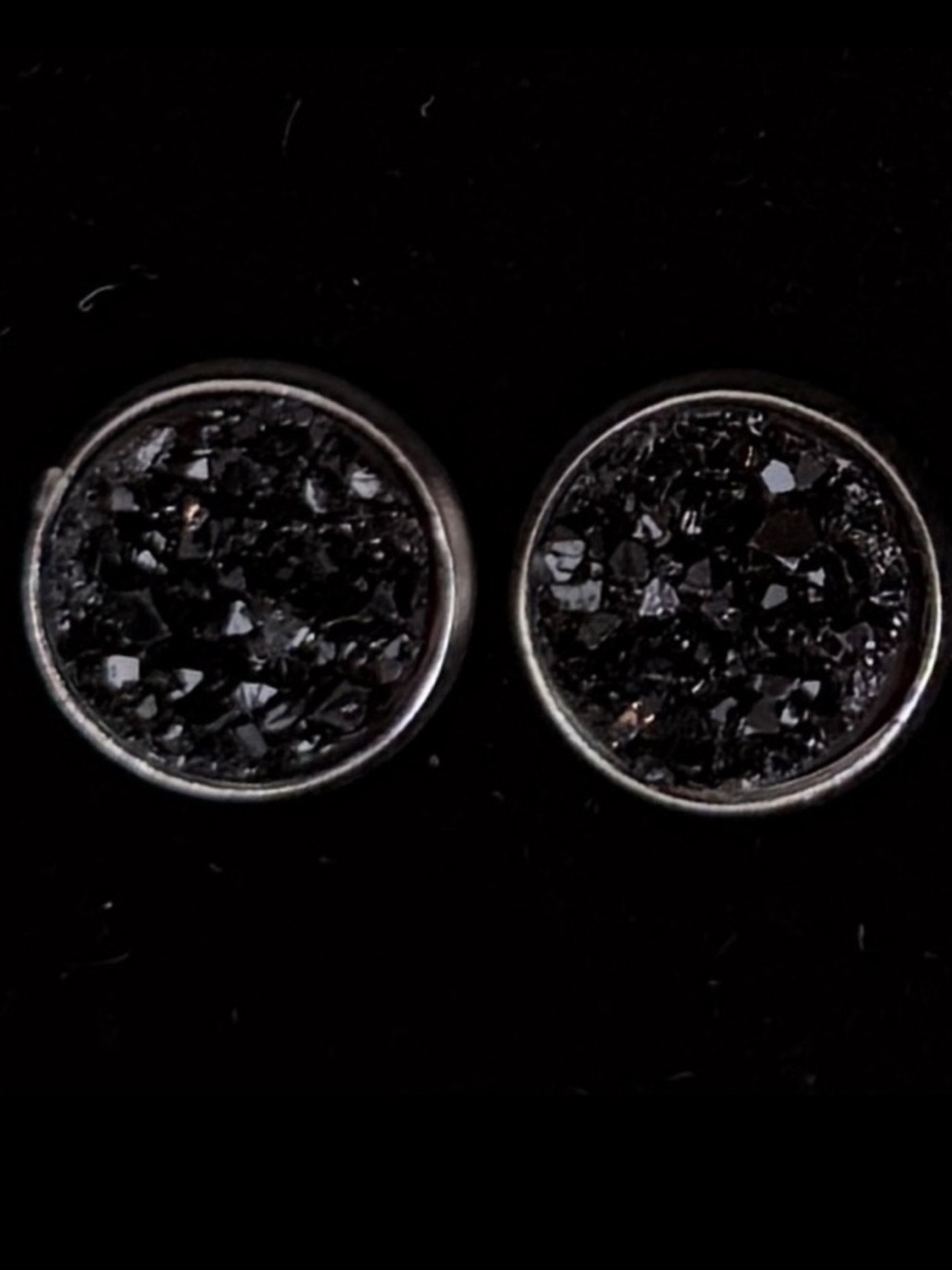 Silvertone and black raised pierced earrings